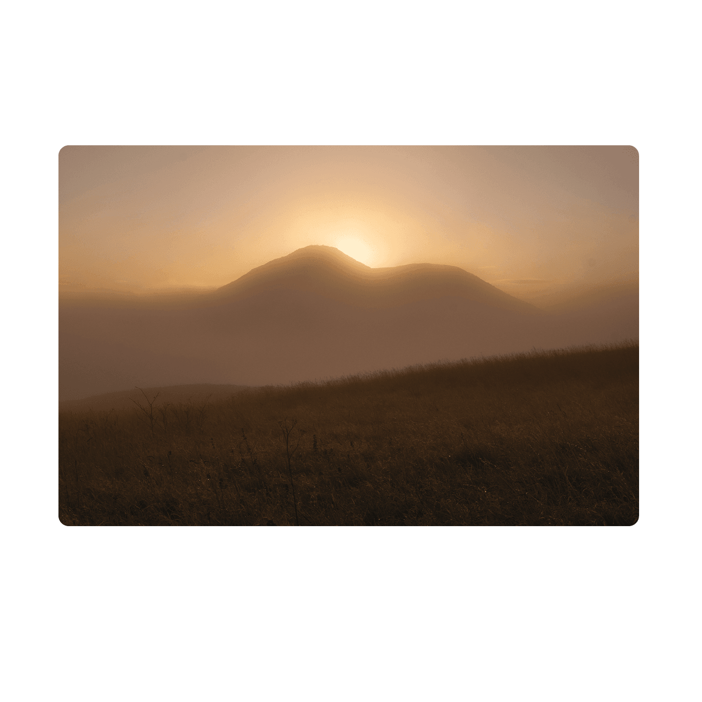 Sunrise breaking over Arthur's Seat through mist, from Holyrood Park, Edinburgh
